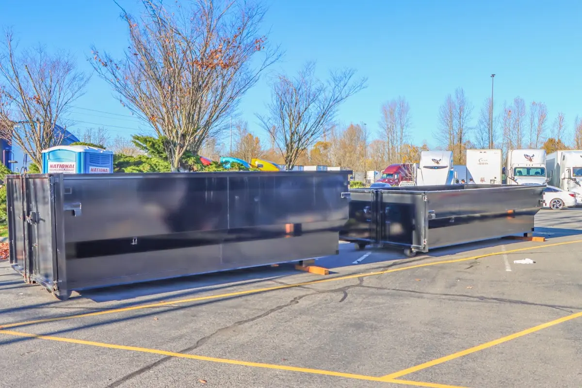 Professional dumpster rental service with roll-off container on residential driveway in Milliken